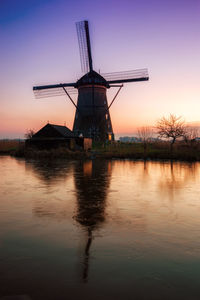 Silhouette of wind turbine at sunset