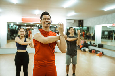 Portrait of young woman exercising in gym