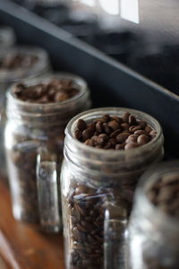 Close-up of coffee beans in glass jar on table