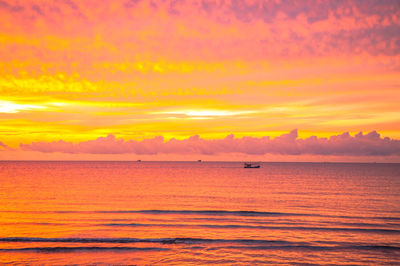 Scenic view of sea against orange sky