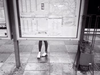 Full length of woman standing by railing