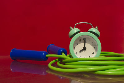 Close-up of bell on table against red background