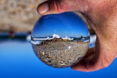 Close-up of hand holding reflection