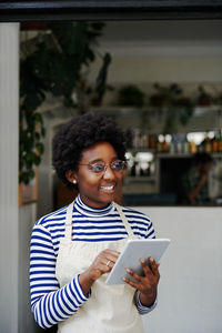 Portrait of smiling young man using mobile phone