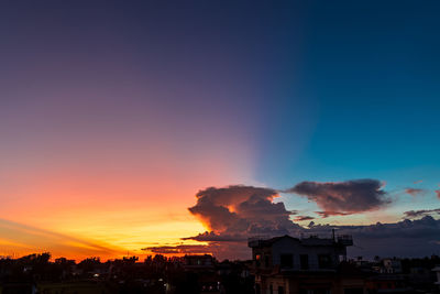 Silhouette buildings against sky during sunset