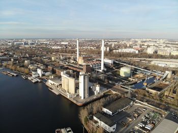 High angle view of river amidst buildings in city against sky