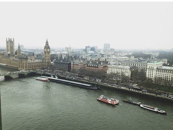 Boats in river with buildings in background