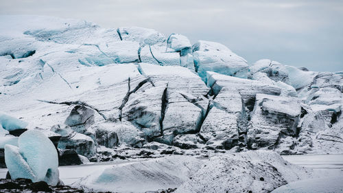 Frozen landscape against sky