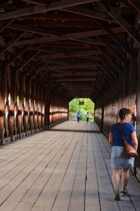 Rear view of people walking on footpath