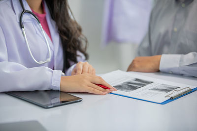 Midsection of woman working on table