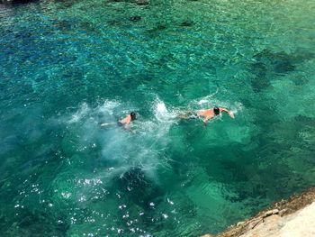 High angle view of people swimming in sea