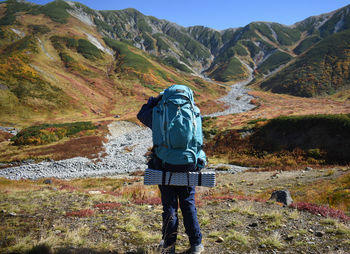 Rear view of man walking on mountain