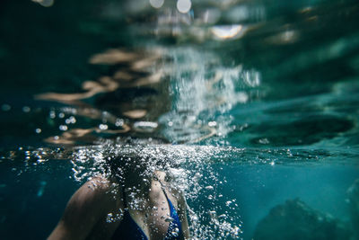 Low section of woman swimming in sea