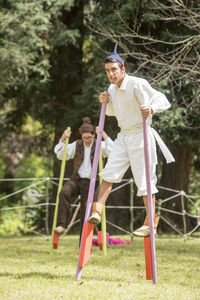 Man playing with umbrella standing on field