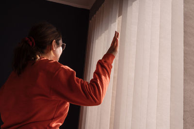 Woman in a room at home near window