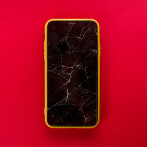 High angle view of broken glass on table against red background