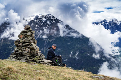 People sitting against mountain range against sky