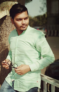 Portrait of young man standing outdoors