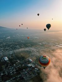 Hot air balloons flying against sky