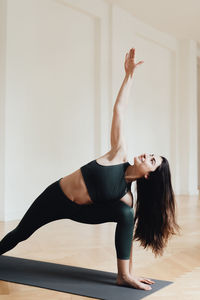 Full length of woman with arms raised