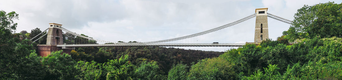 Low angle view of bridge against cloudy sky