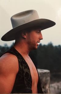 Side view of young man wearing hat