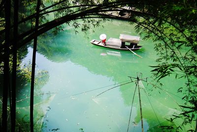 Boat on lake against trees