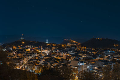 High angle view of illuminated buildings in city at night