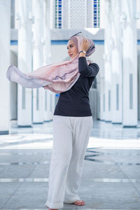 Young woman standing in front of building