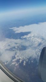 Cropped image of airplane wing over landscape