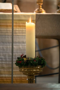 Close-up of lit candles on table