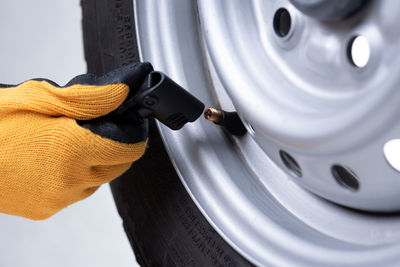 Cropped hand of man repairing car