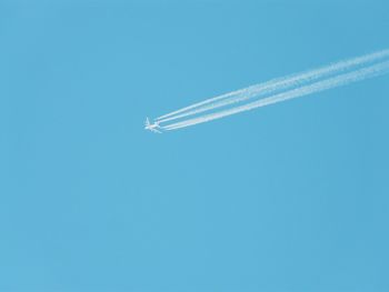 Low angle view of airplane flying in sky