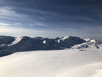 Scenic view of snowcapped mountains against sky