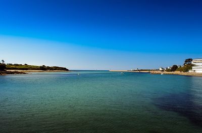 Scenic view of sea against clear blue sky