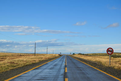 Empty road amidst land