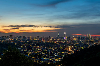 High angle view of illuminated buildings against sky during sunset