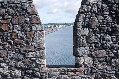 Looking out from a castle wall to the sea at carrickfergus, northern ireland