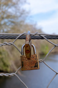 Close-up of padlocks on fence