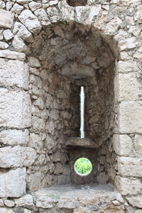 Close-up of stone wall with hole