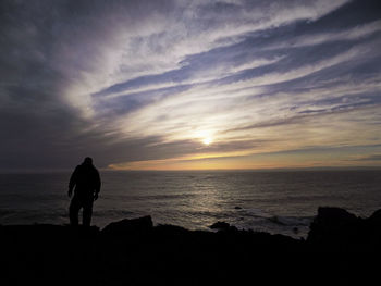 Silhouette of people standing on beach