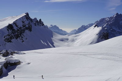 Scenic view of snow covered mountains against sky