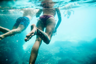 Close-up of young woman swimming in pool