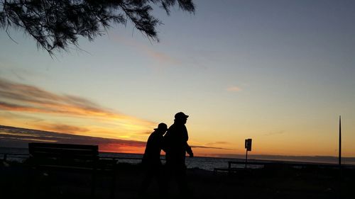 Silhouette of people at sunset