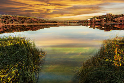 Scenic view of lake against sky during sunset