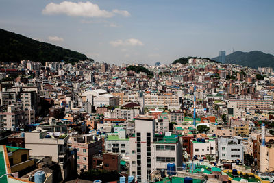 View of cityscape against cloudy sky