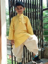 Portrait of boy standing on bicycle