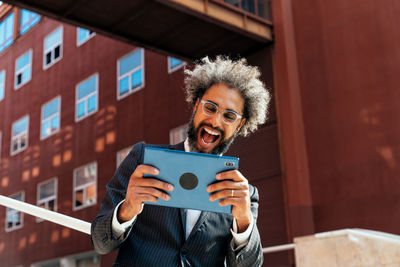 Portrait of young woman using digital tablet