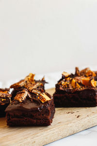 Close-up of chocolate cake on table against white background