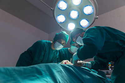 Group of doctor, concentrated doctor in a patient during a hysterectomy operation in a hospital.